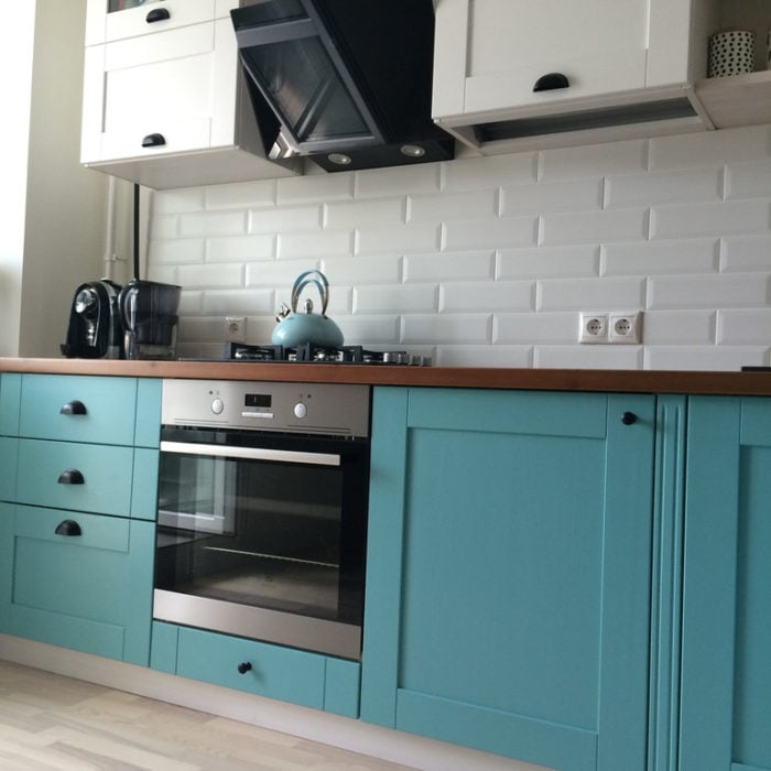 turquoise lower cabinets with white upper cabinets in the kitchen