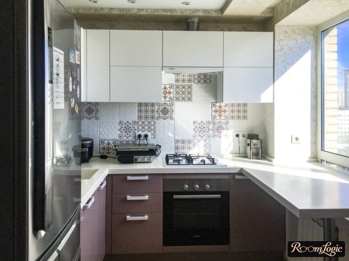 U-shaped countertop extending to window sill in tiny apartment kitchen
