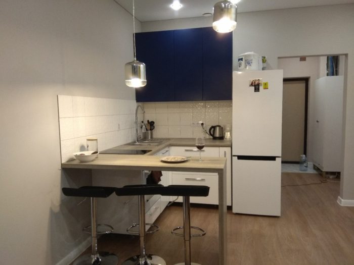 U-shaped kitchen cabinets in studio apartment