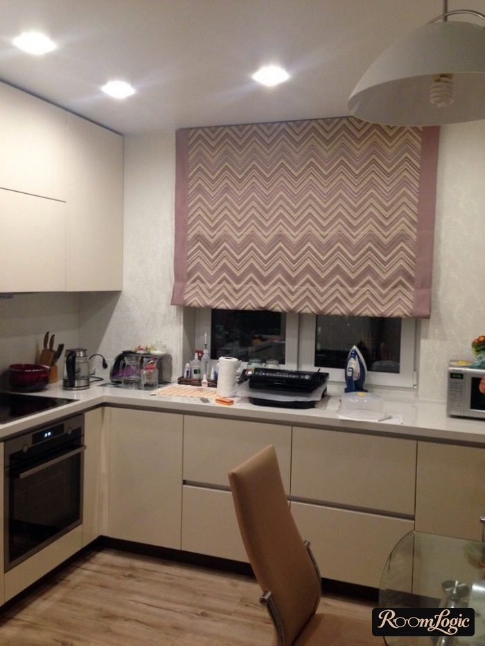 U-shaped kitchen with a window and Roman shades