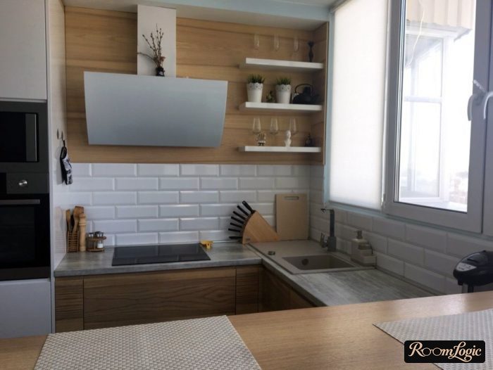 U-shaped white kitchen with wood