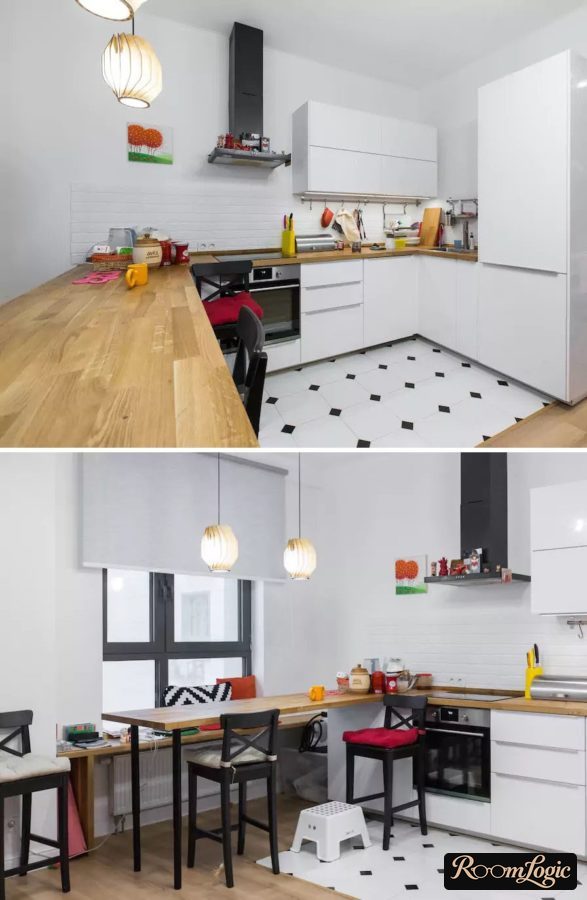U-shaped white kitchen with wooden breakfast bar by the window