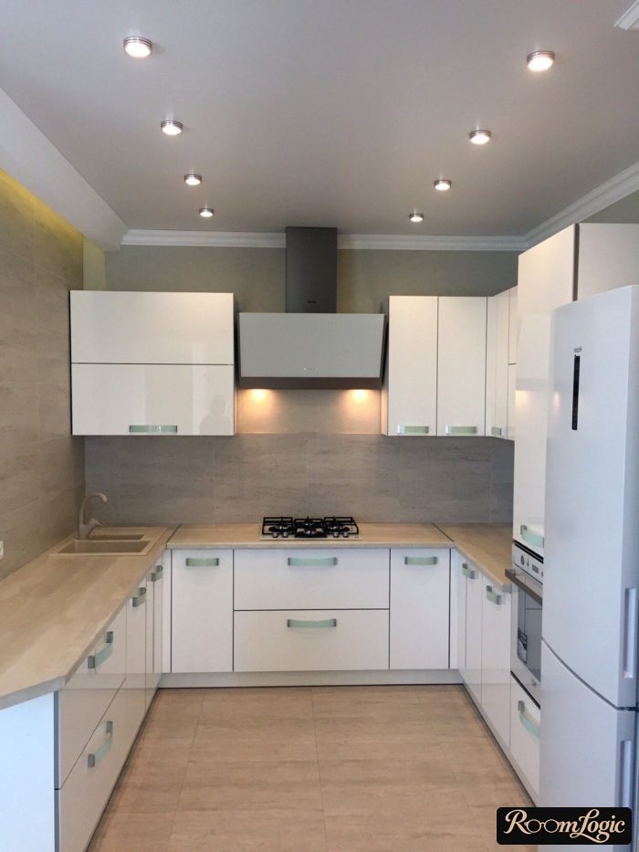 U-shaped white kitchen without a window