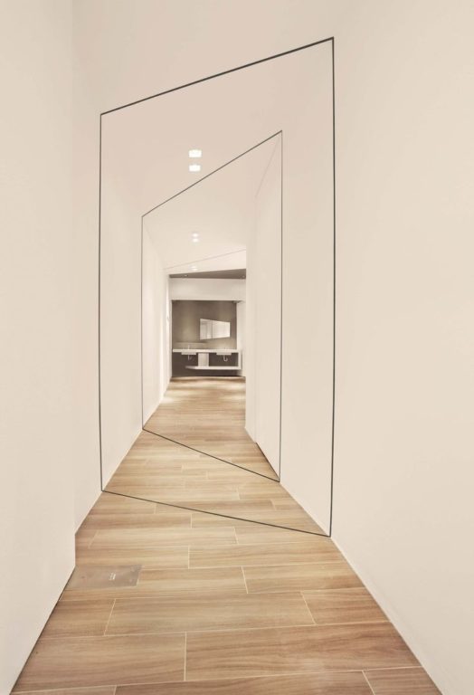 uneven hallway with white walls