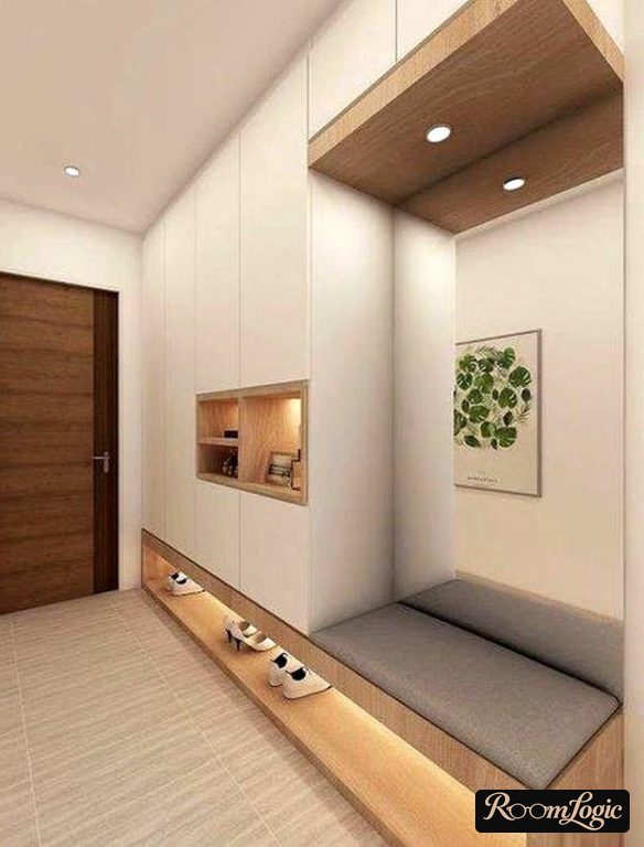 Upholstered bench built into an entryway wardrobe with shoe storage underneath