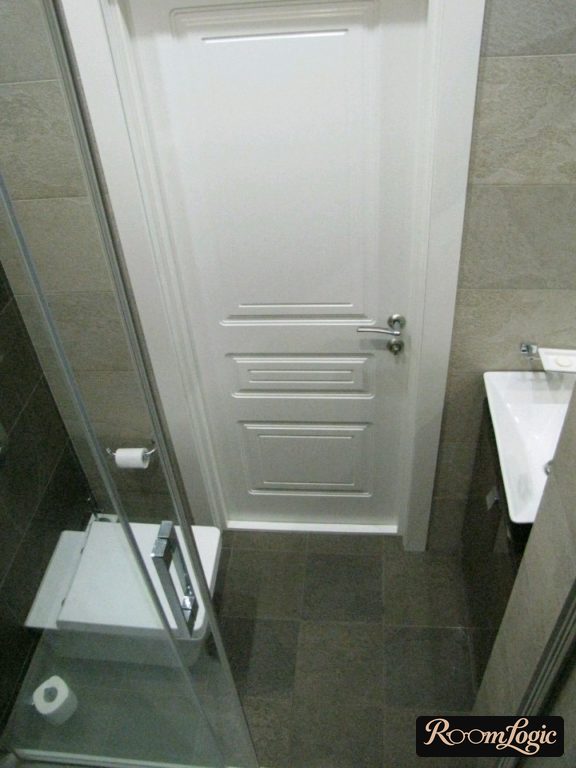 very small bathroom with shower and toilet