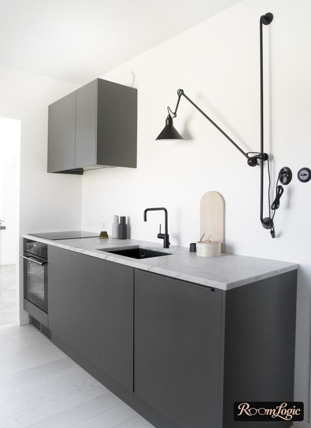 wall-mounted adjustable pendant light on a pole in a kitchen without upper cabinets