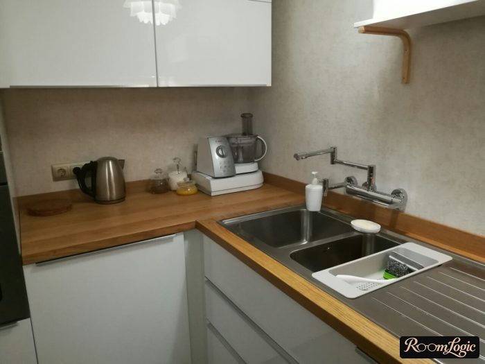 wall mounted faucet at the corner of the kitchen