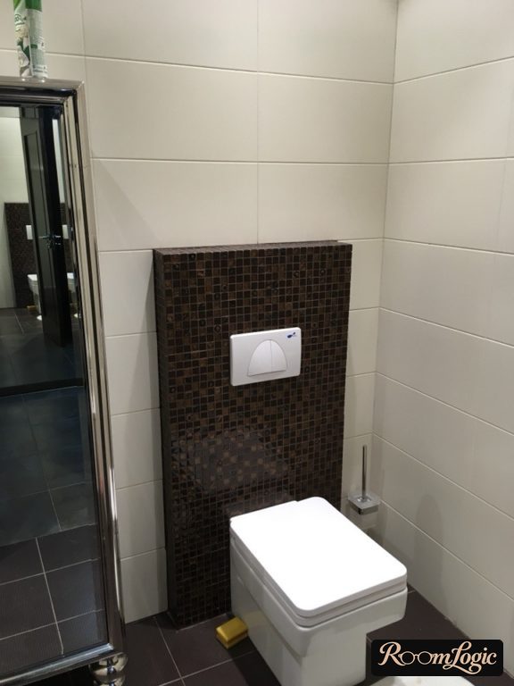 Wall-mounted toilet brush in the toilet