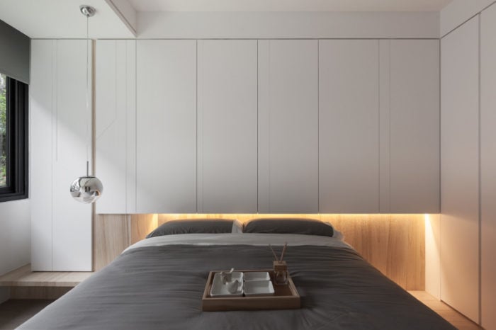 wall with laminate behind the bed in the bedroom