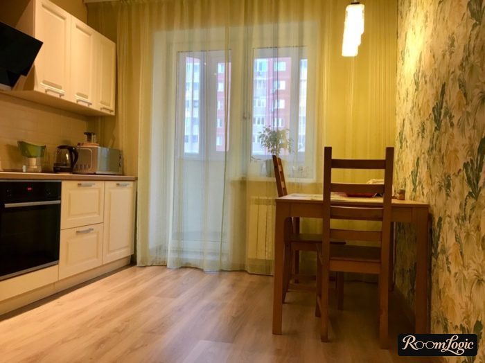 wallpaper and curtains in the kitchen with a balcony door