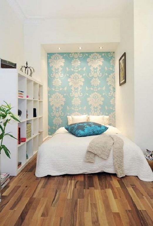 wallpaper on a narrow wall behind the bed