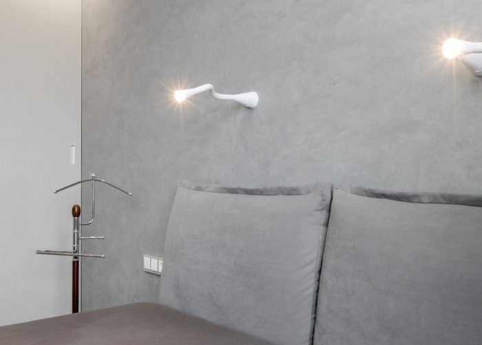 walls and bedding in a small bedroom are the same color