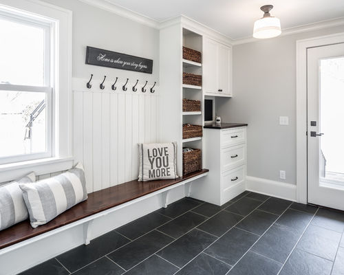 wardrobe and open hanging racks in a large entryway