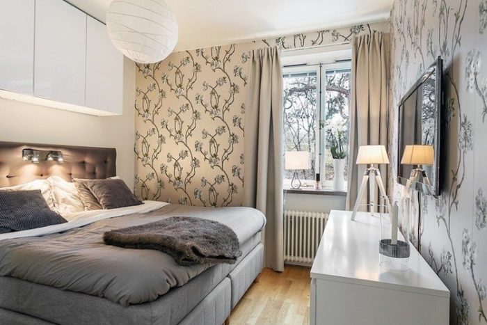 Wardrobes above a bed in a small bedroom