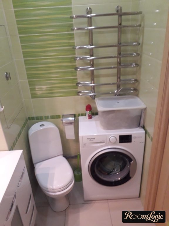 washer in bathroom of tiny apartment