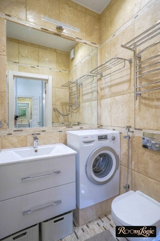 Washing machine on a platform in the bathroom