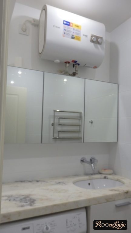 Water heater above the mirror in the bathroom