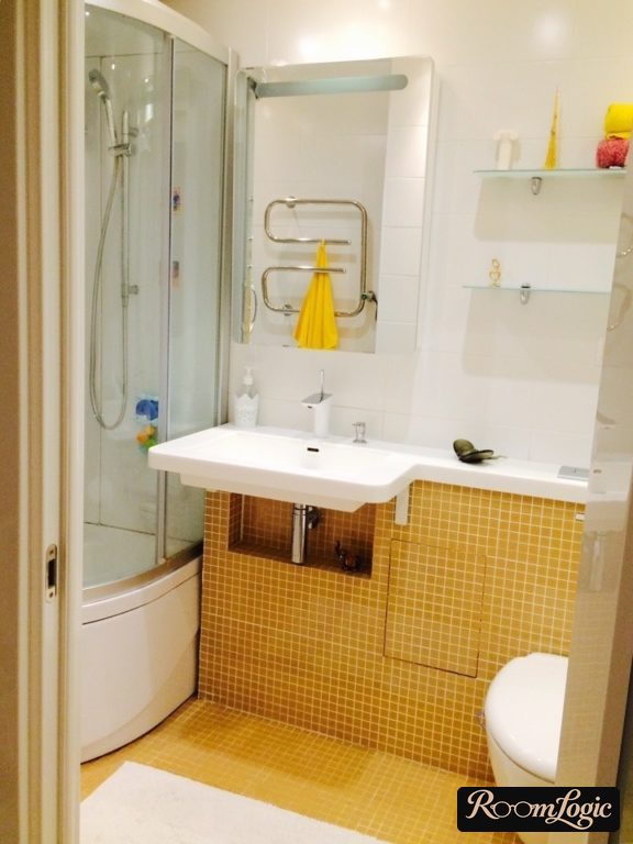 white and yellow bathroom design with a shower enclosure