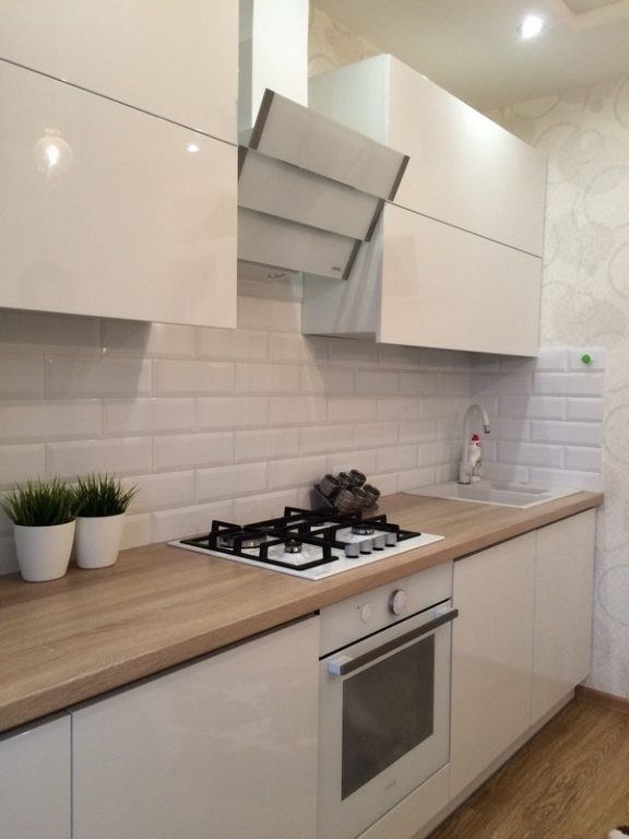 White appliances on a white kitchen with wooden countertops