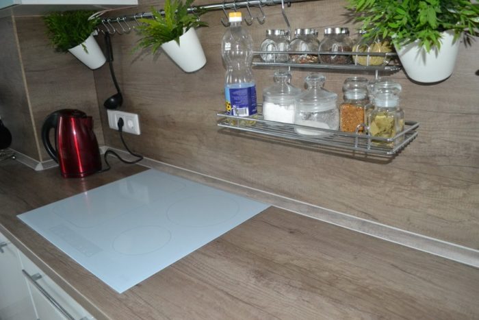 White cooktop on wooden countertop