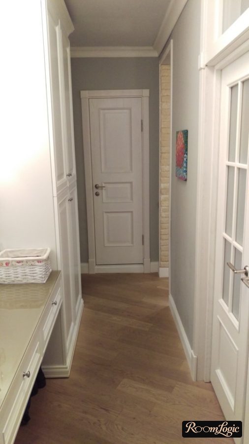 White doors with routed detailing in the hallway