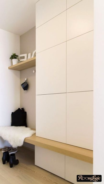 White entryway with bench in small hallway
