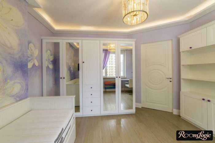 White furniture and purple wall paper for a teenage girl