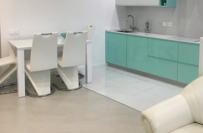 White glossy square tile on the kitchen floor