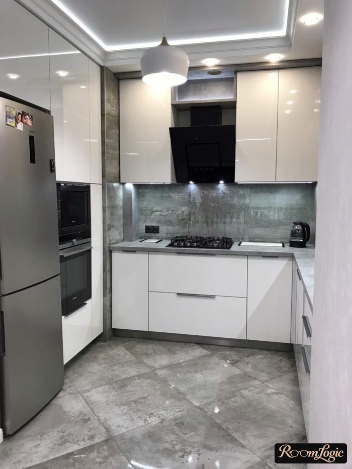 white glossy U-shaped kitchen with refrigerator