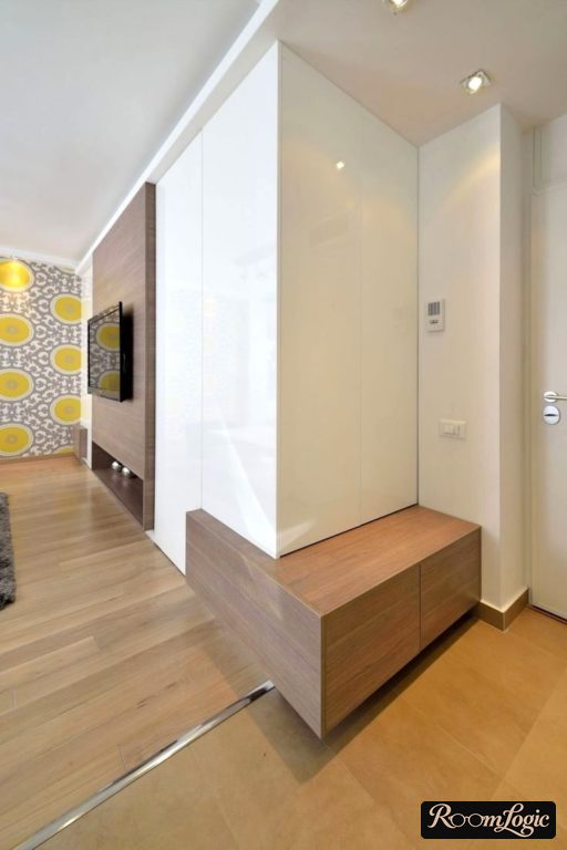 White glossy wardrobe with seating in the small hallway