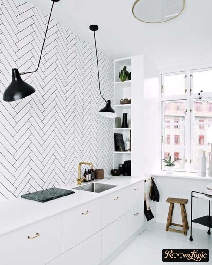 White herringbone bricks on a kitchen wall without upper cabinets