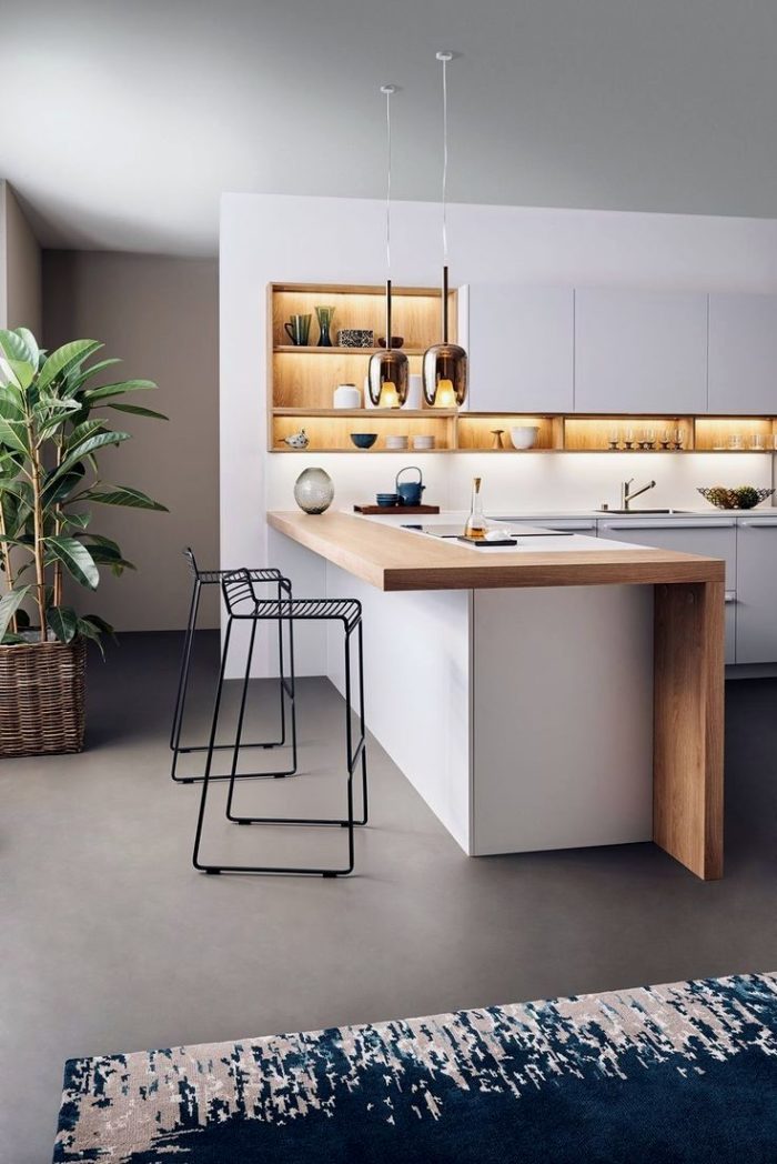 White kitchen combined with living room featuring a self-leveling floor in a minimalism style