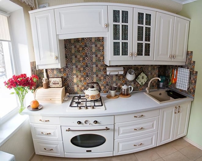 White kitchen in Provence style in a tiny apartment