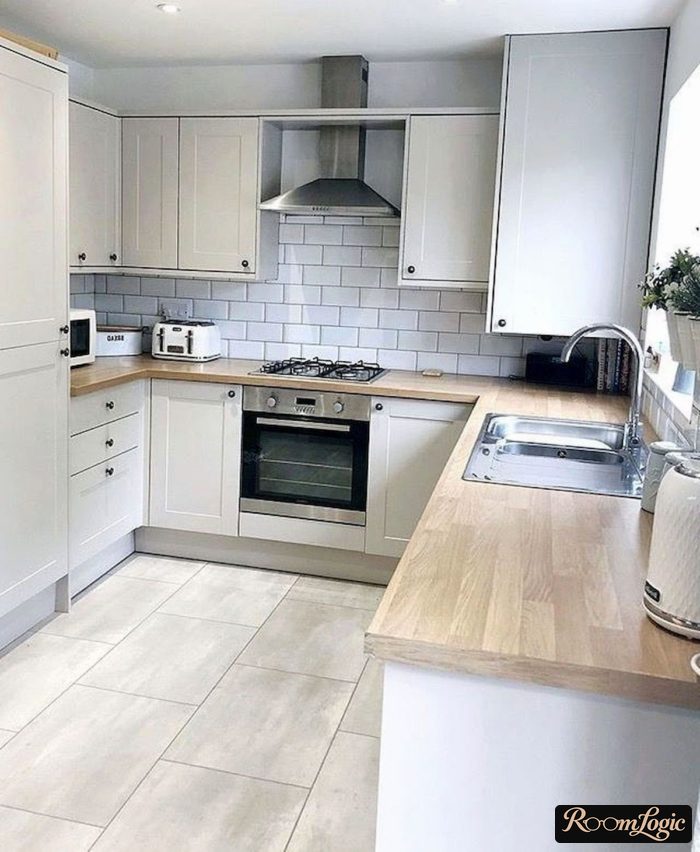 white kitchen in scandi style with brick backsplash