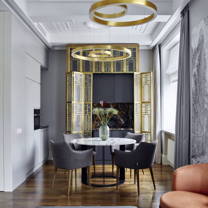 white kitchen with golden accents in art deco style