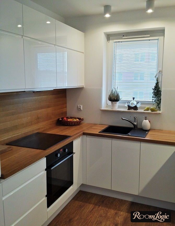 White kitchen with wooden countertop and backsplash