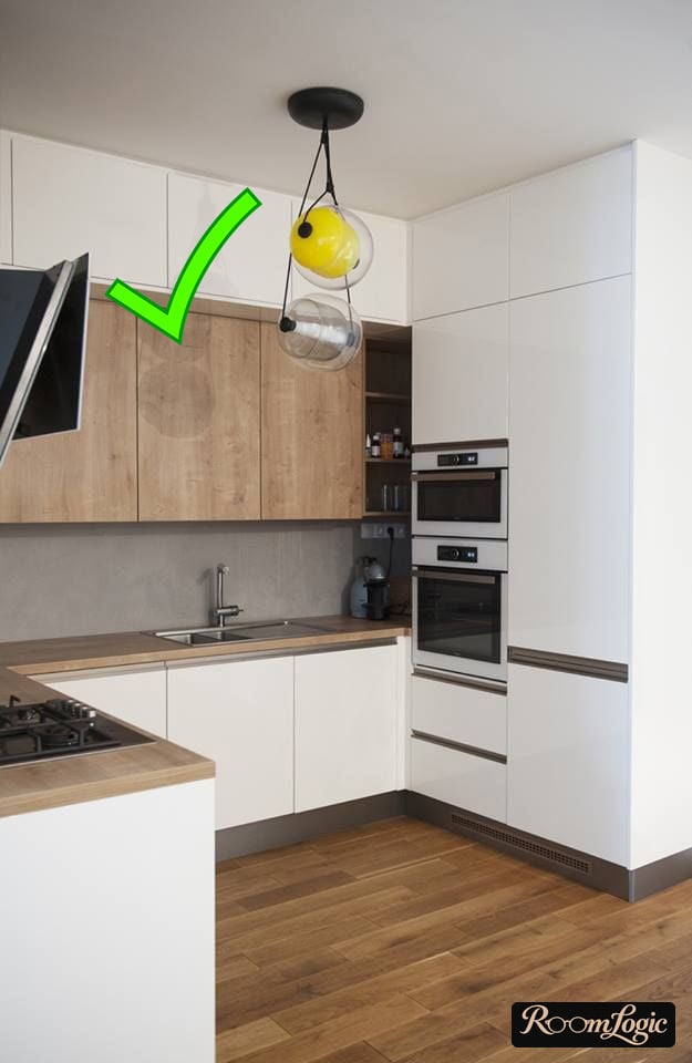White kitchen with wooden countertop and flooring