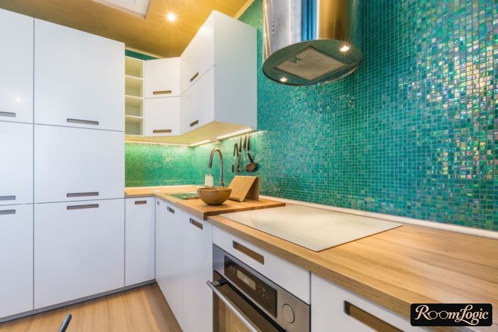 white kitchen with wooden countertop and green mosaic backsplash