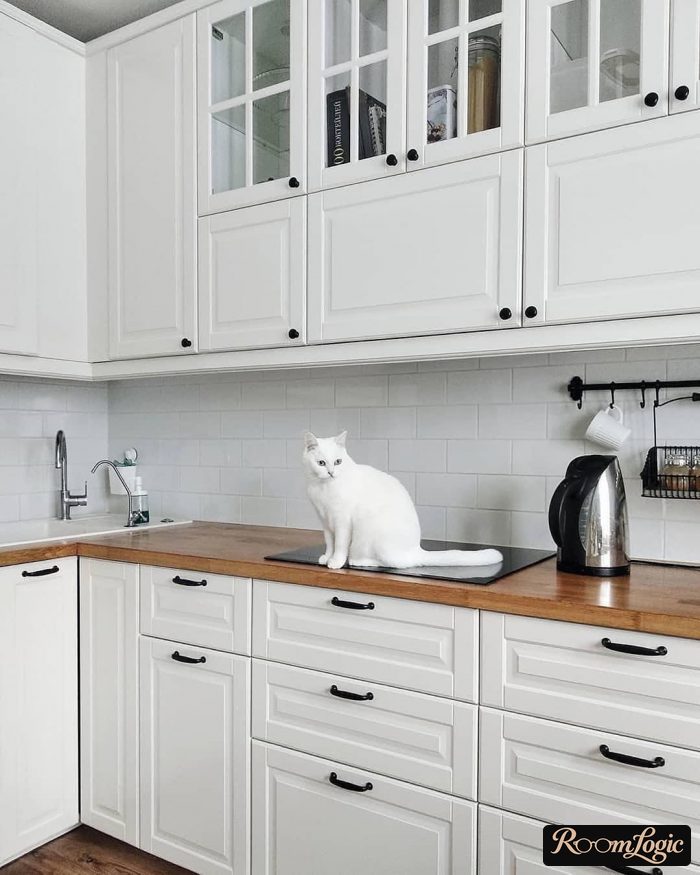 white kitchen with wooden countertop in scandi style
