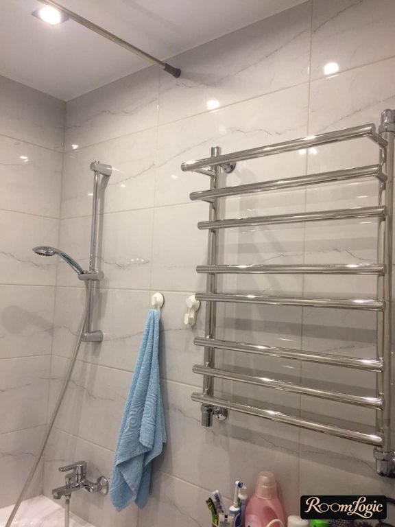 white matte suspended ceiling in the bathroom of a tiny apartment
