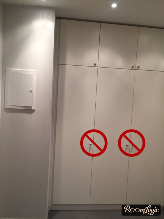 White minimalist built-in wardrobe in narrow hallway