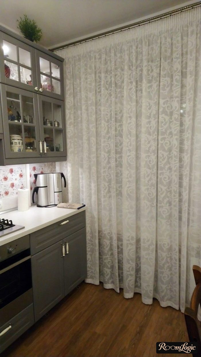 White sheer curtain with a pattern in a gray kitchen