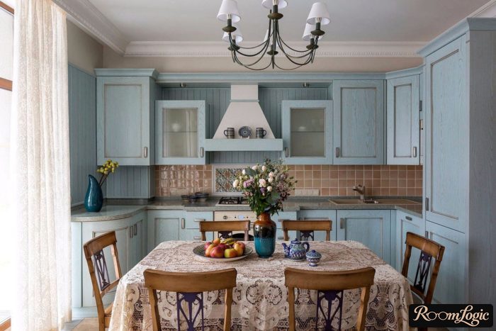 White sheer curtains in a light blue Provence-style kitchen