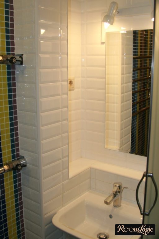 White subway tile around the sink on the wall