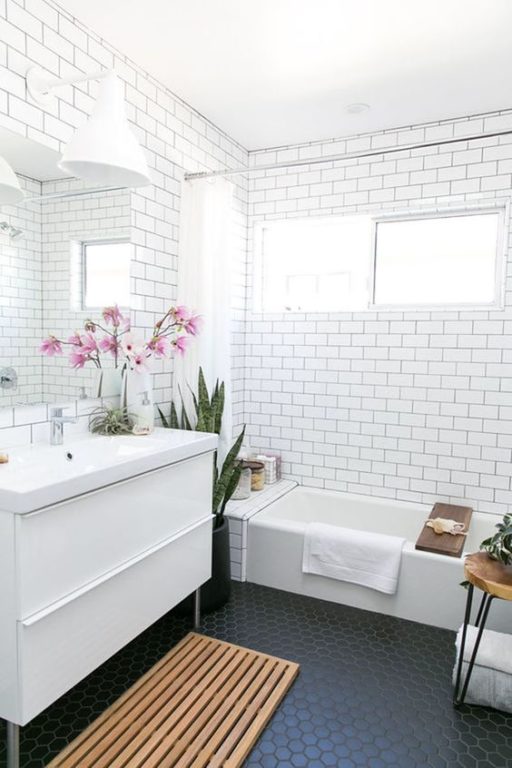 white subway tile with black grout in the bathroom design