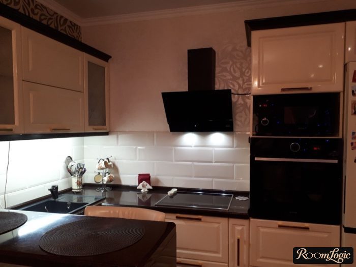 white U-shaped kitchen with black countertop