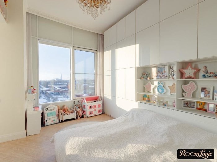 White wall cabinet reaching the ceiling behind the bed in the teenager girl's bedroom