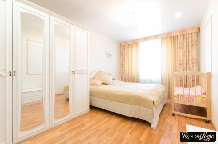 white wardrobe in the bedroom with a kids' bed