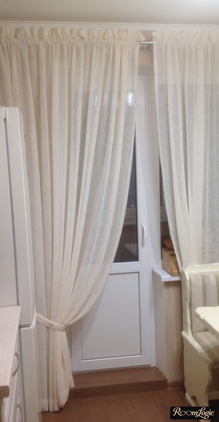 Window treatments secured with straps in the kitchen with a balcony